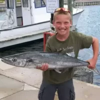 Catch It Fishing Charters & Tours Gallery Image| Young boy holding fresh caught fish from a deep sea fishing tour | Catch It Fishing Charters & Tours in Panama City Beach offers family friendly, deep sea fishing trips ranging from 3 hours to 12 hours, and dolphin tours and sightseeing boat tours along the Gulf Coast.