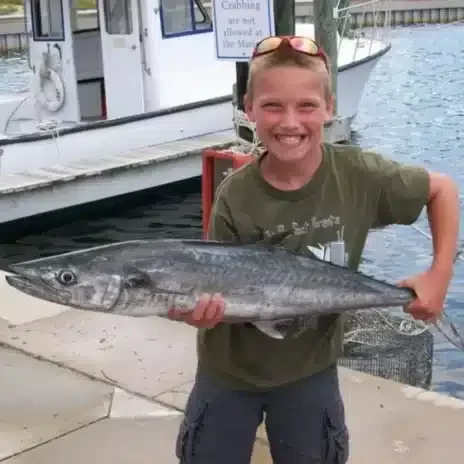 Catch It Fishing Charters & Tours Gallery Image| Young boy holding fresh caught fish from a deep sea fishing tour | Catch It Fishing Charters & Tours in Panama City Beach offers family friendly, deep sea fishing trips ranging from 3 hours to 12 hours, and dolphin tours and sightseeing boat tours along the Gulf Coast.