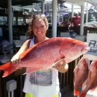 Catch It Fishing Charters & Tours Gallery Image | Young girl holding fresh caught fish from a deep sea fishing tour | Catch It Fishing Charters & Tours in Panama City Beach offers family friendly, deep sea fishing trips ranging from 3 hours to 12 hours, and dolphin tours and sightseeing boat tours along the Gulf Coast.